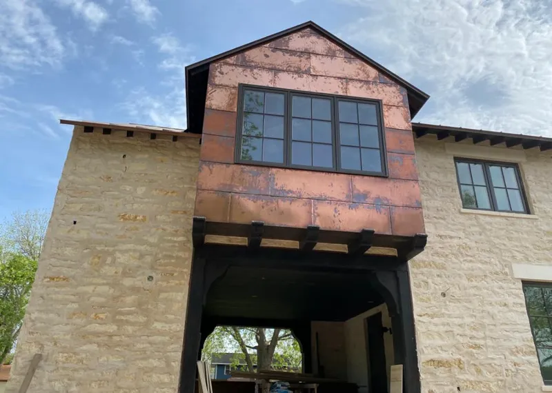 Copper metal panel facade on a stone building for Roof Repair in Douglass Hills