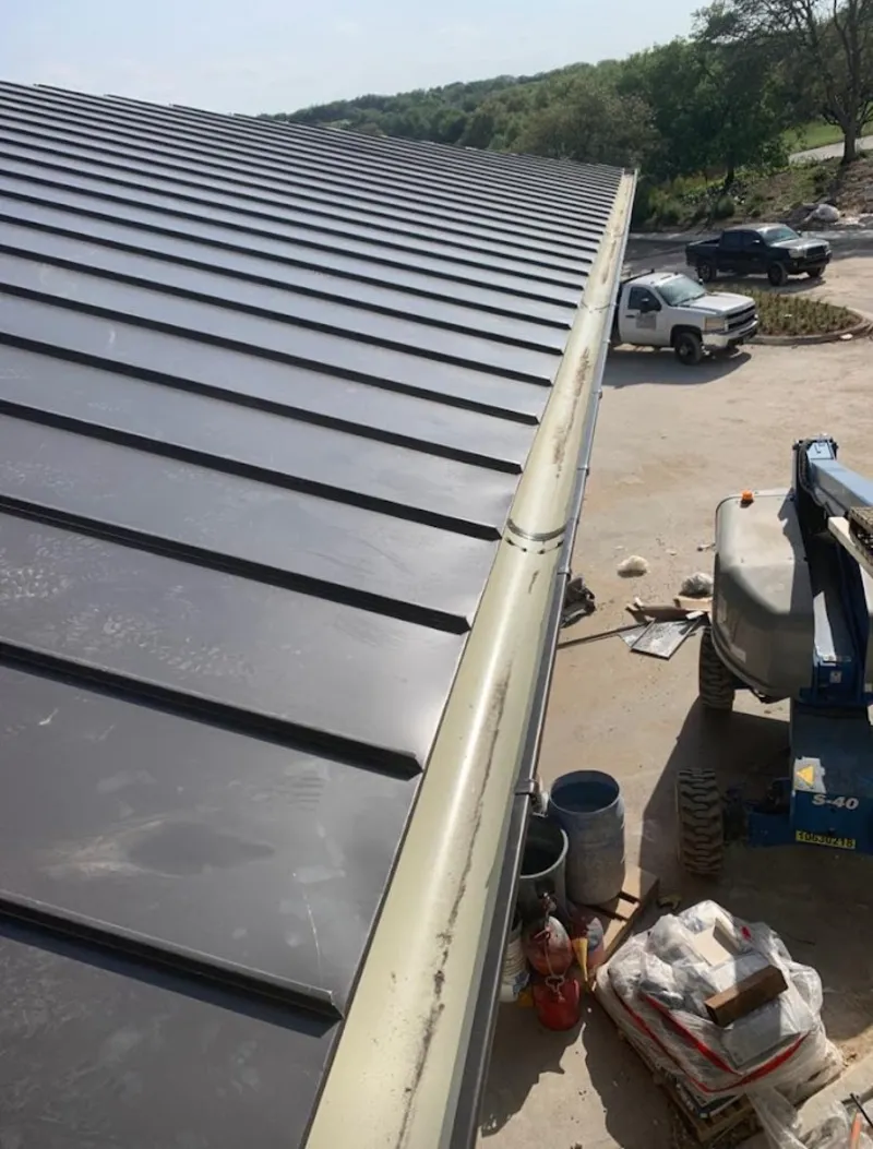 Standing seam panel and gutter detail on a metal roofing jobsite in Douglass Hills